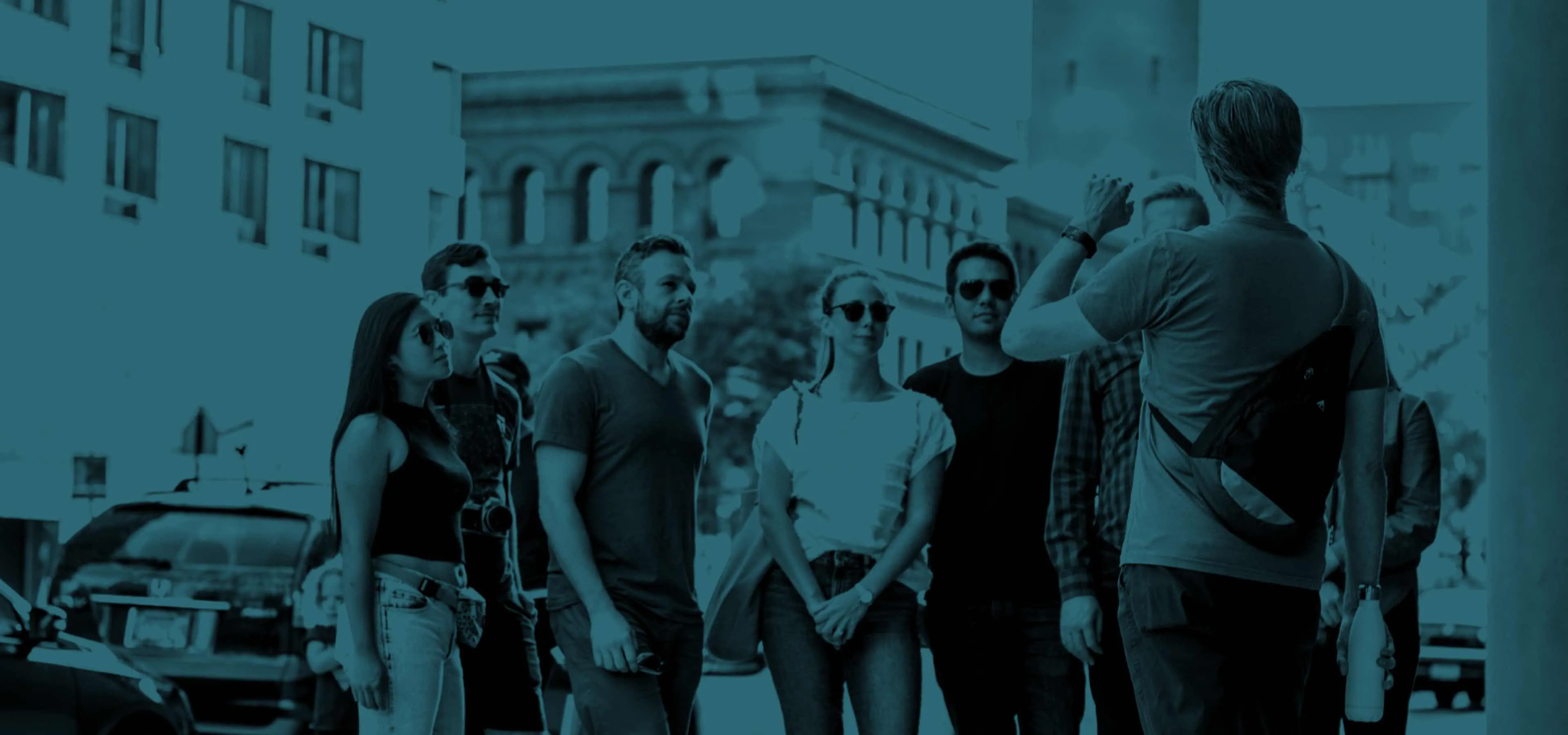 Tour group exploring a city with a digital guidebook on their phones