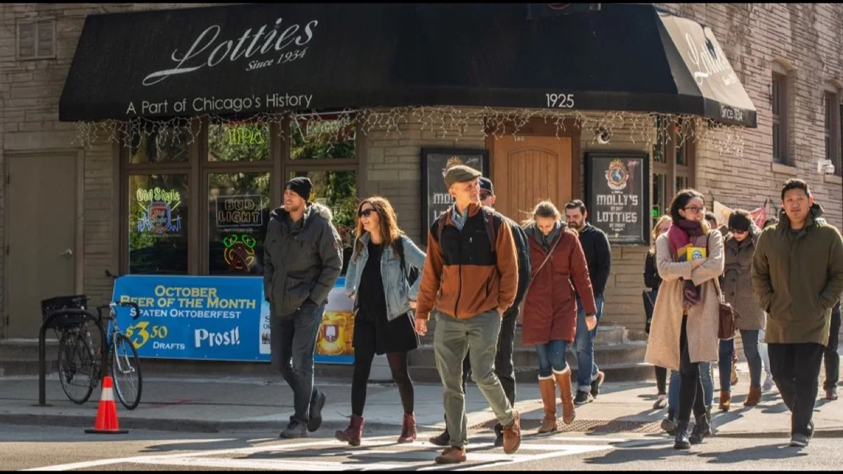 Tour guide leading a group on a walking food experience